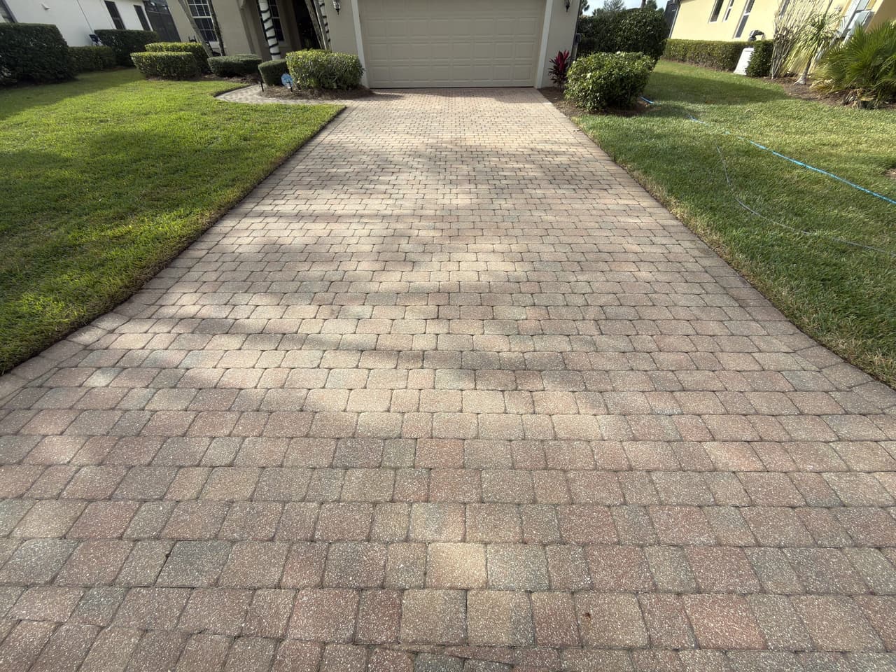 Worn, faded pavers before restoration