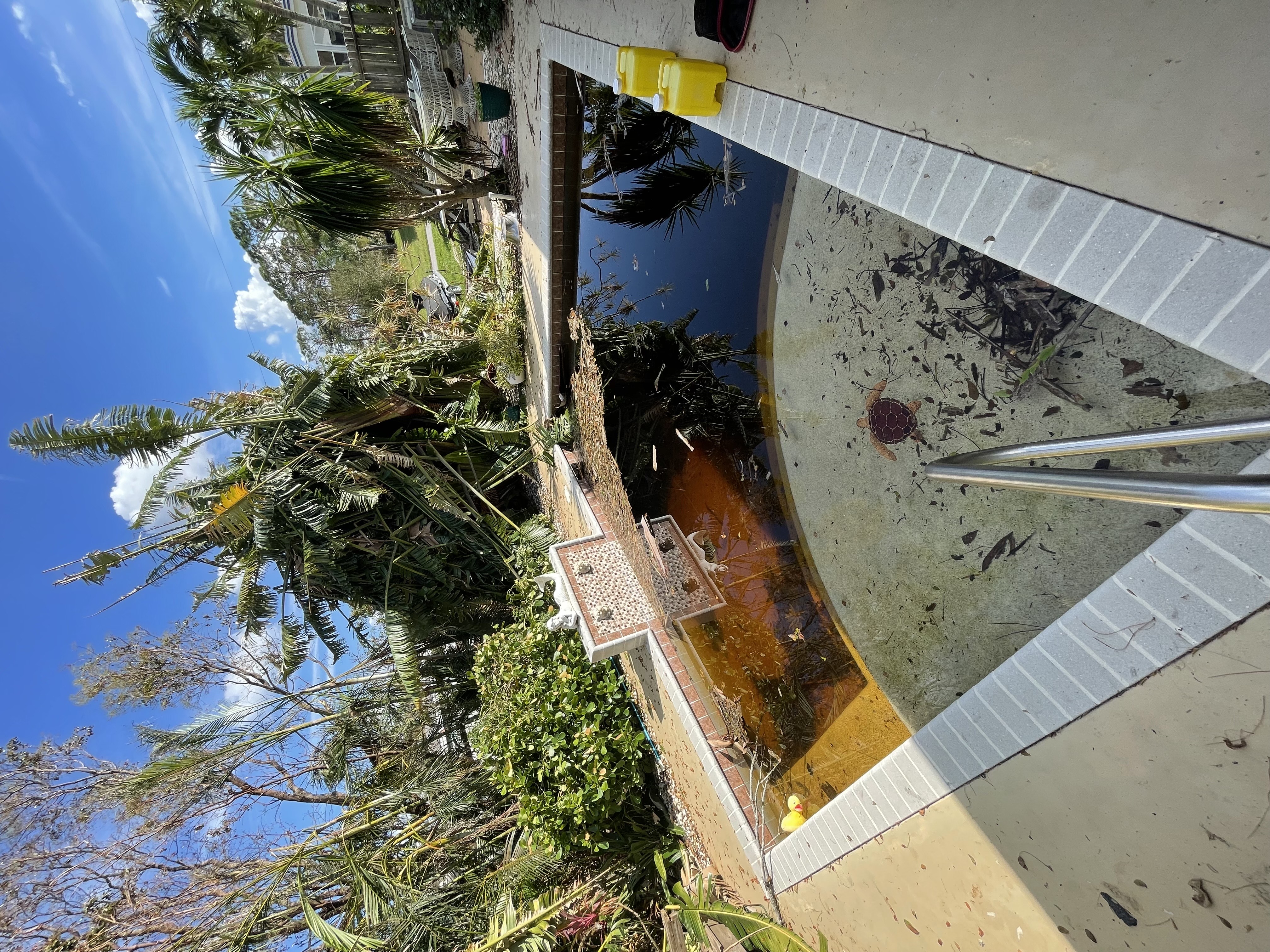 Pool filled with debris after hurricane, Cape Coral FL