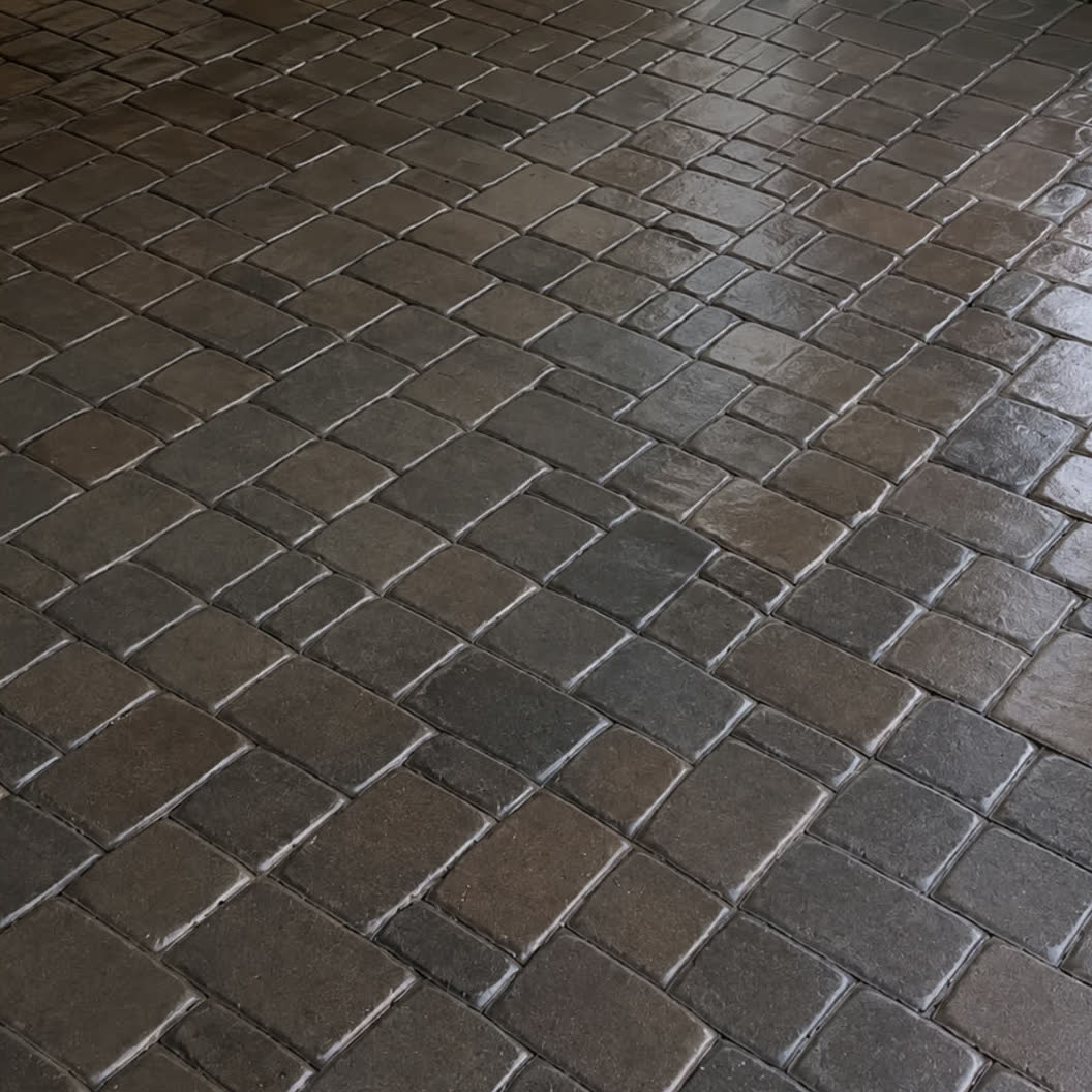 Cobblestone pavers after restoration and sealing — deep, even colour restored
