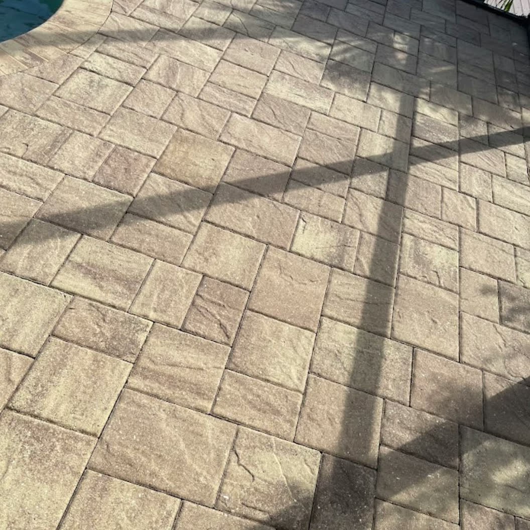 Paver pool deck before sealing — flat, dry and sun-faded